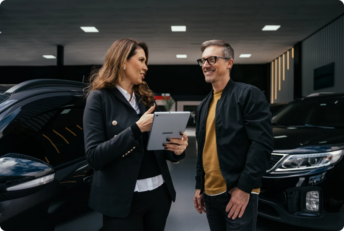 Car dealership discussion with tablet